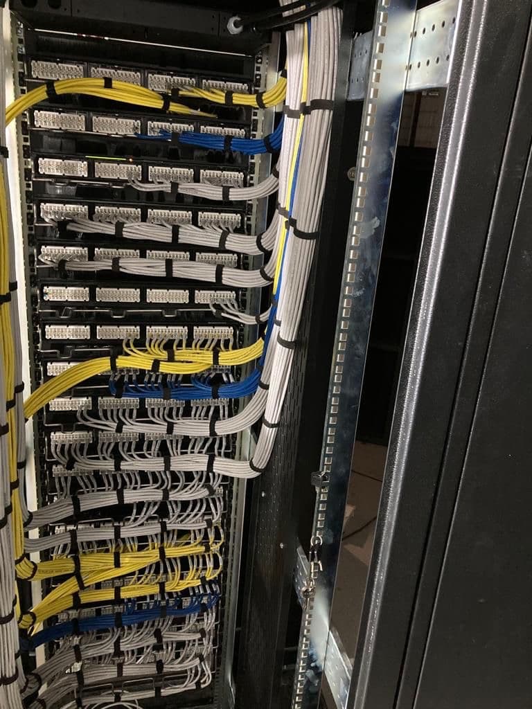 Cleanly dressed structured network cabling and patch panels in a commercial server rack